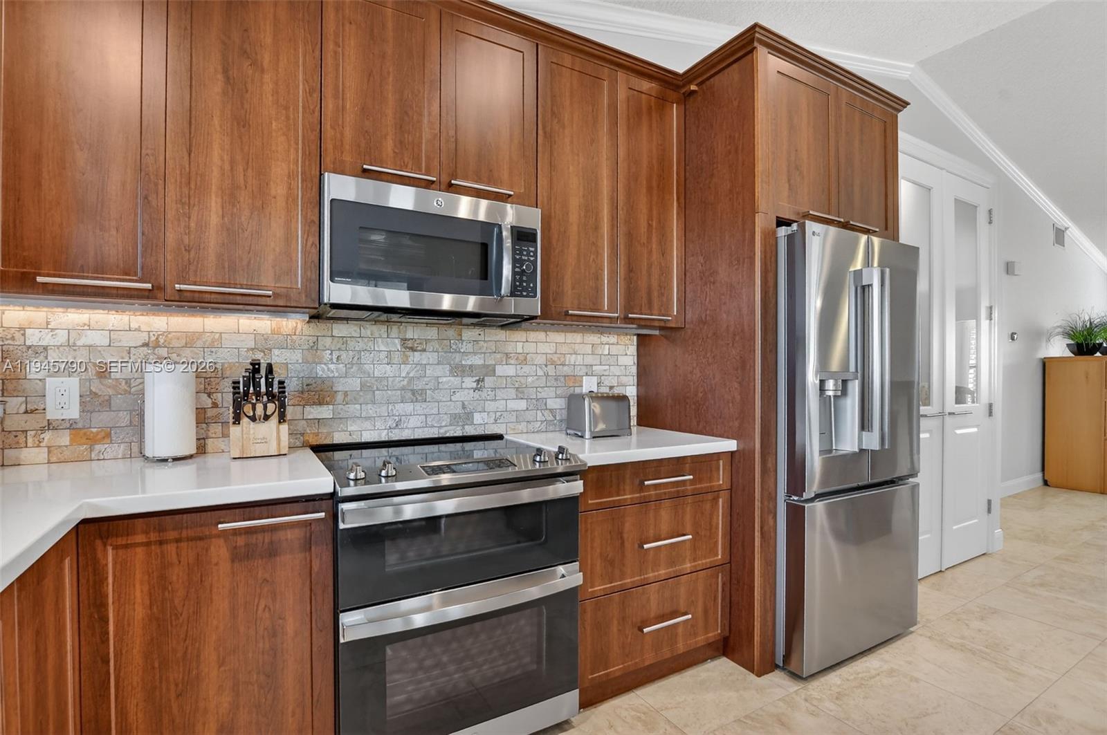 9943 Majorca Place Boca Raton, FL 33434 - Photo 21 of 48 a kitchen with stainless steel appliances granite countertop a refrigerator stove and microwave