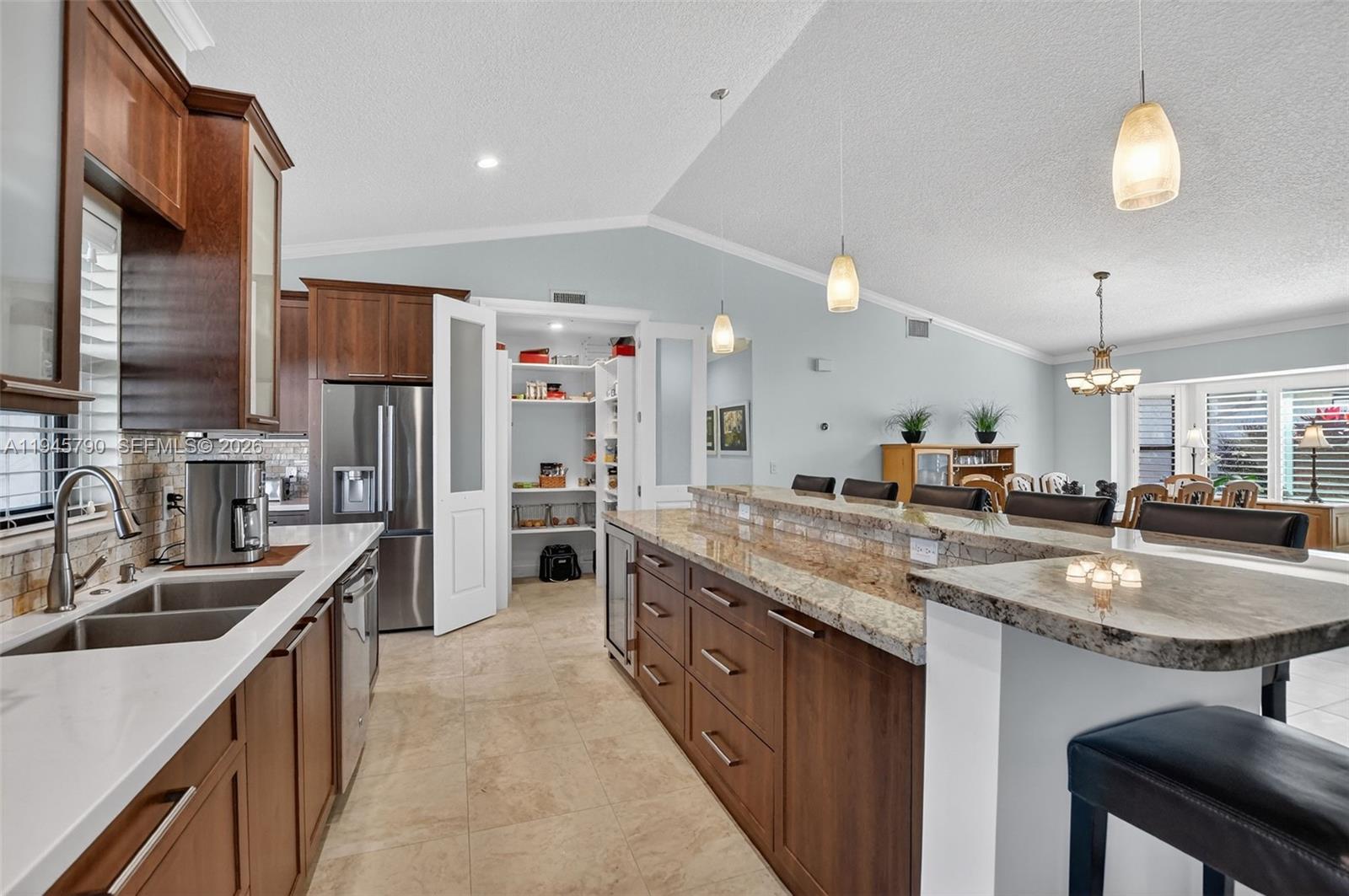 9943 Majorca Place Boca Raton, FL 33434 - Photo 22 of 48 a kitchen with stainless steel appliances granite countertop a sink a stove and a refrigerator