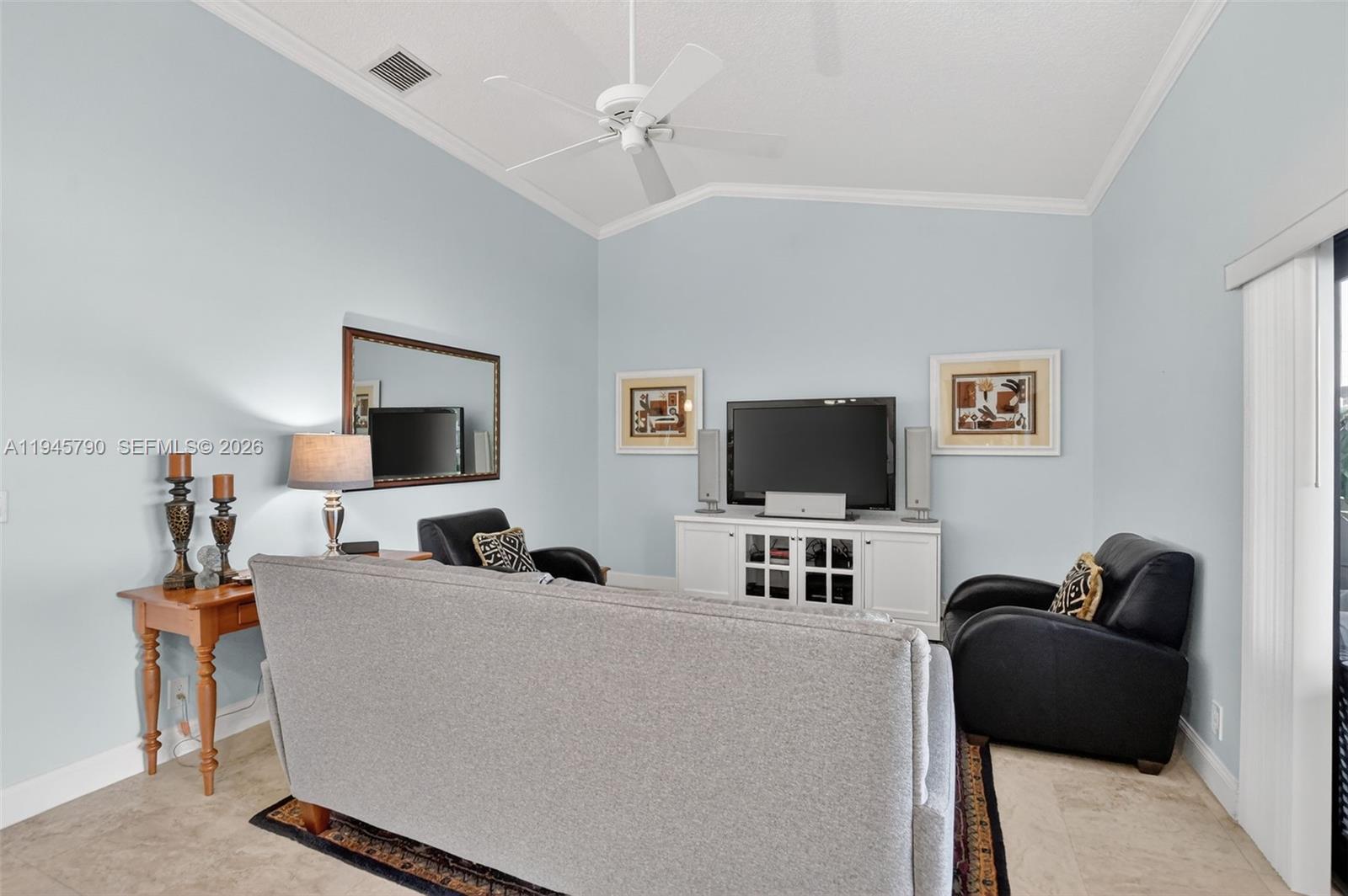 9943 Majorca Place Boca Raton, FL 33434 - Photo 24 of 48 a living room with furniture and a flat screen tv