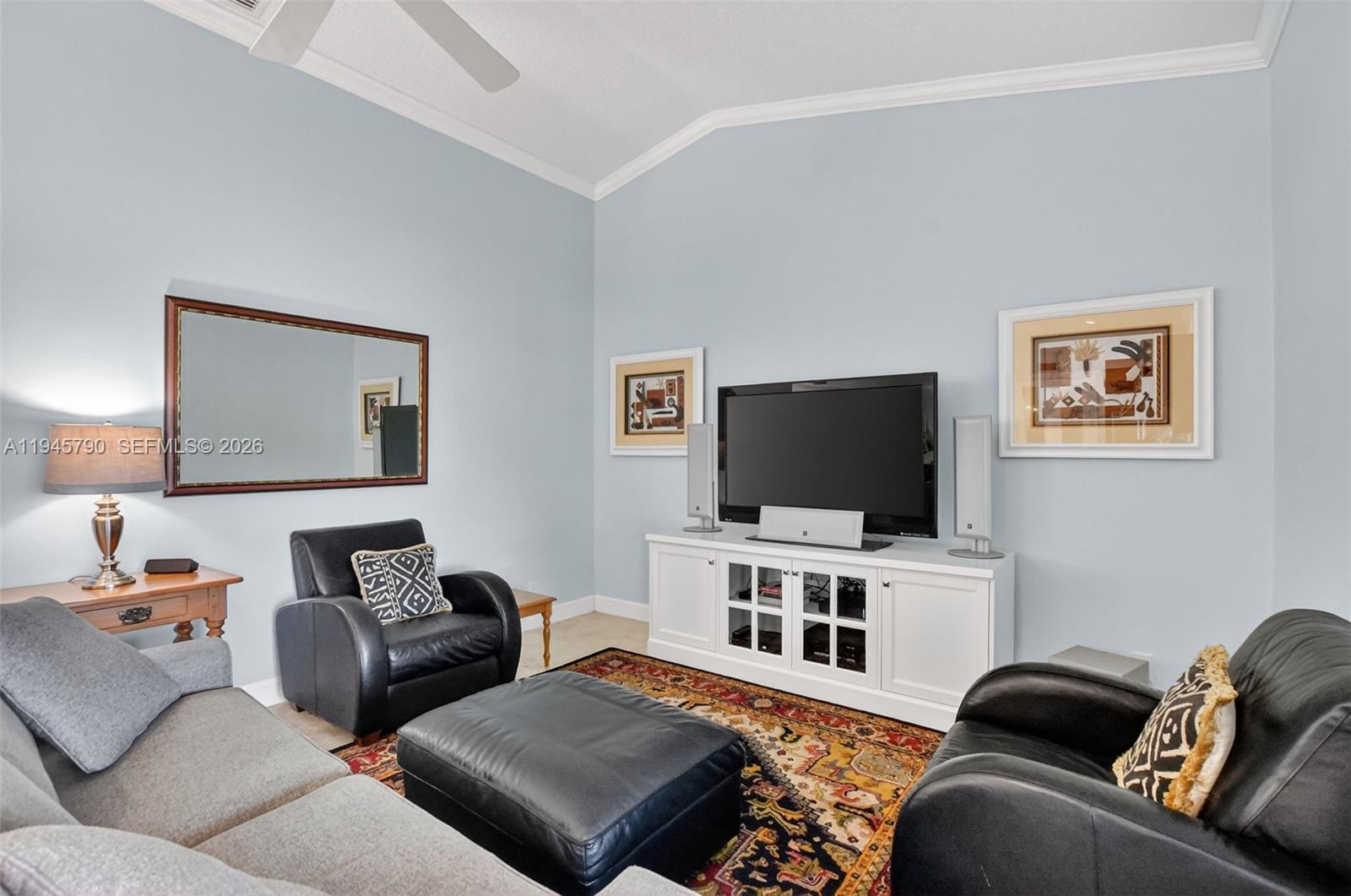 9943 Majorca Place Boca Raton, FL 33434 - Photo 25 of 48 a living room with furniture and a flat screen tv