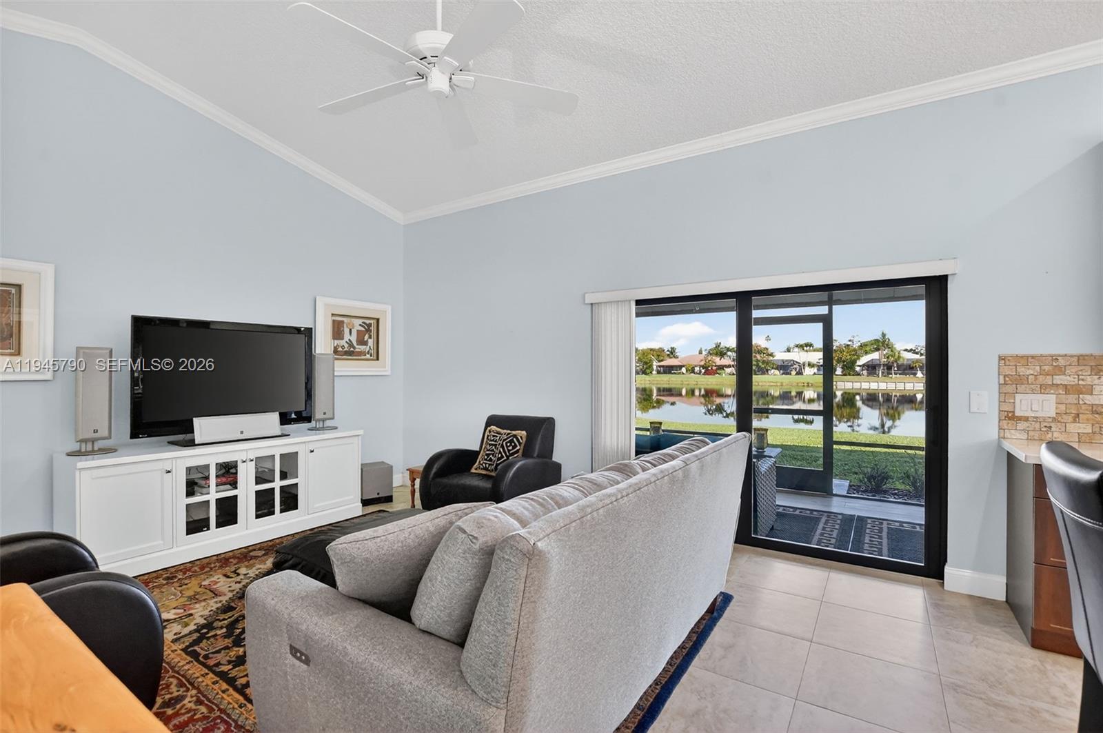 9943 Majorca Place Boca Raton, FL 33434 - Photo 27 of 48 a living room with furniture and a flat screen tv