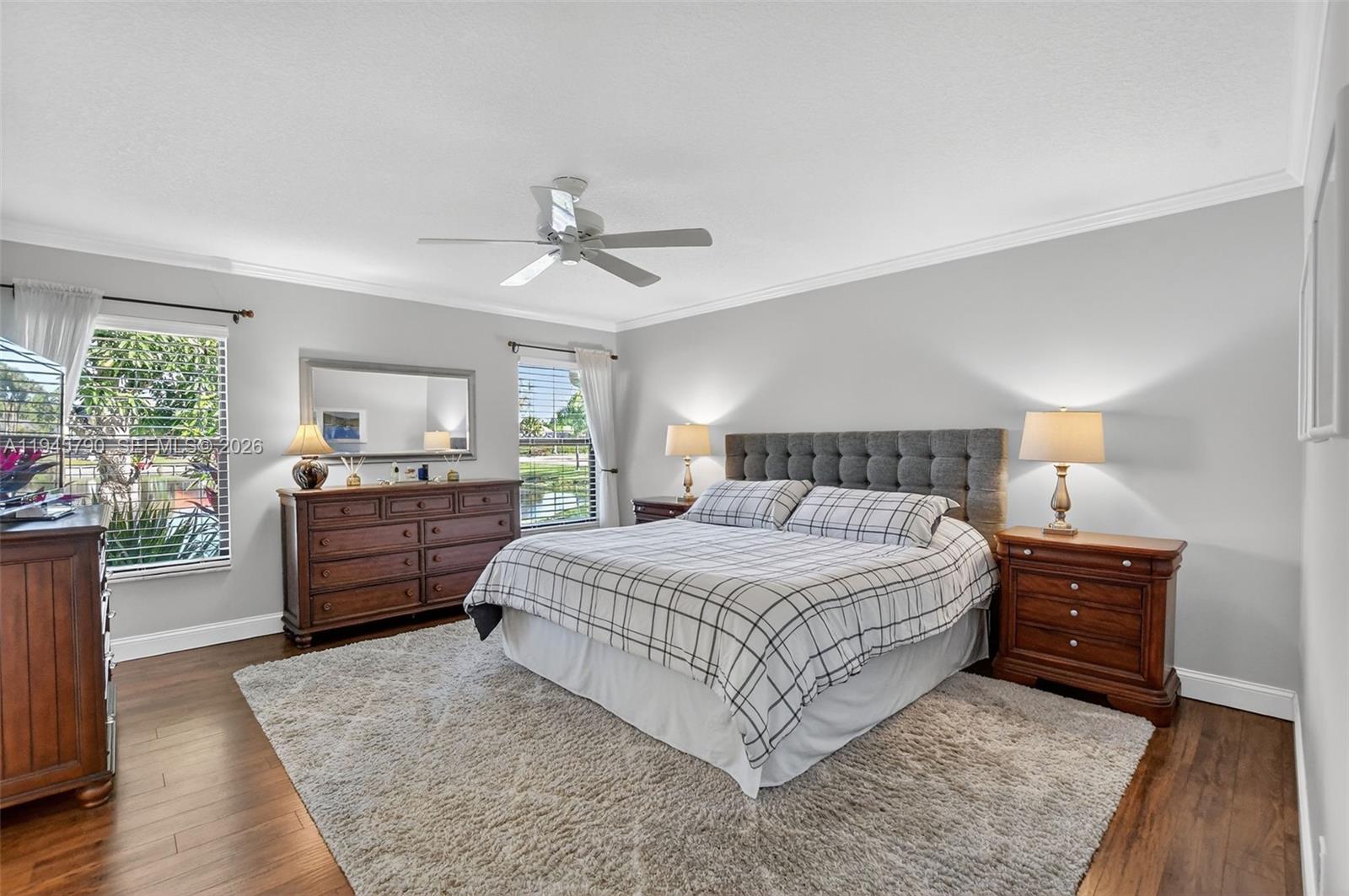 9943 Majorca Place Boca Raton, FL 33434 - Photo 28 of 48 a bedroom with a bed and dresser with mirror