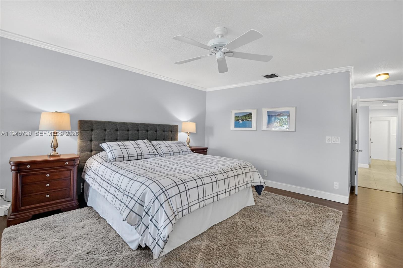 9943 Majorca Place Boca Raton, FL 33434 - Photo 30 of 48 a bedroom with a bed and a lamp