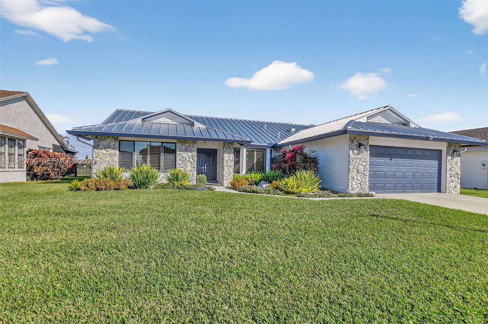 9943 Majorca Place Boca Raton, FL 33434 - Photo 3 of 48 a front view of a house with garden