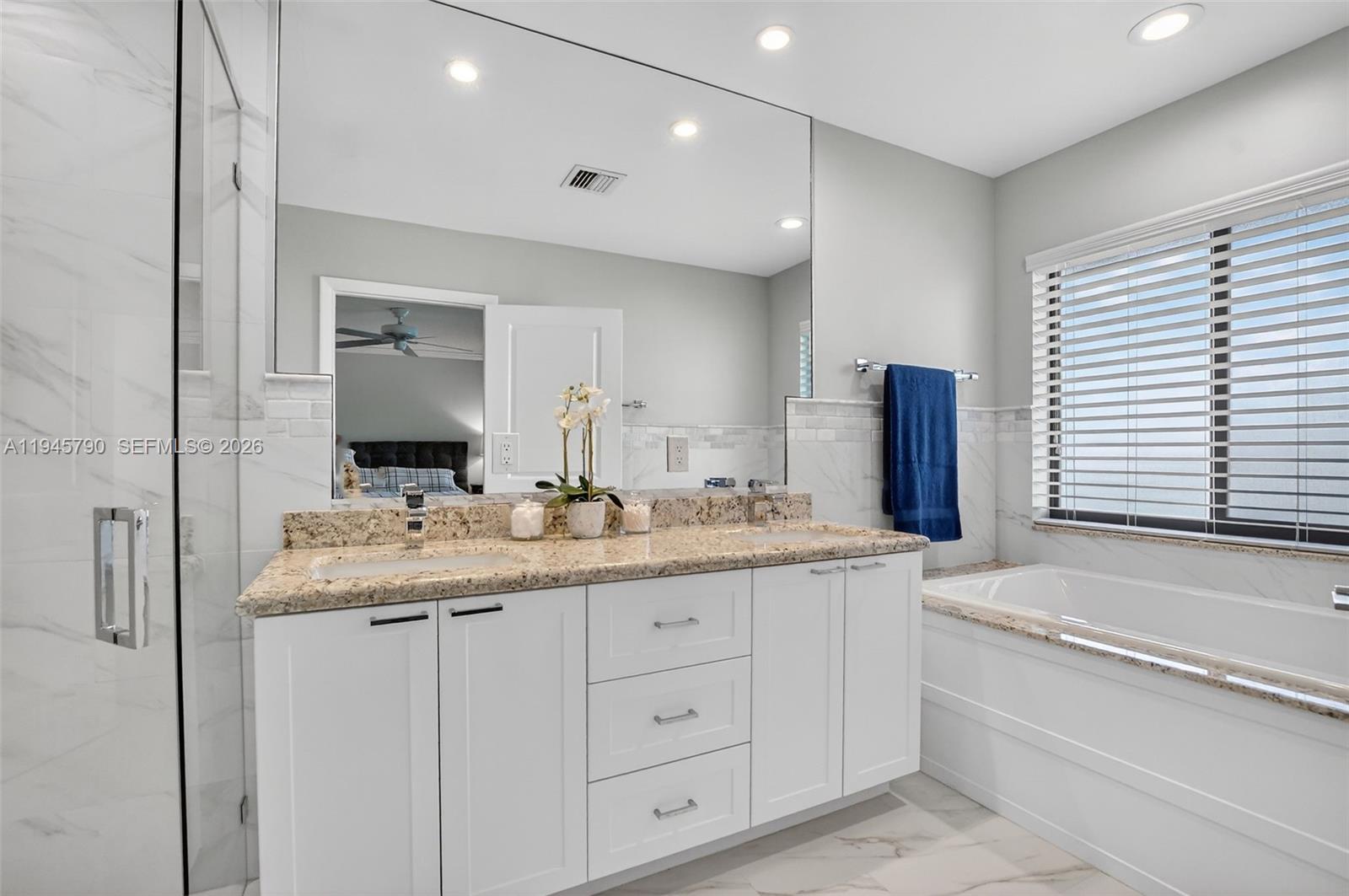 9943 Majorca Place Boca Raton, FL 33434 - Photo 31 of 48 a bathroom with a granite countertop double vanity sink and mirror