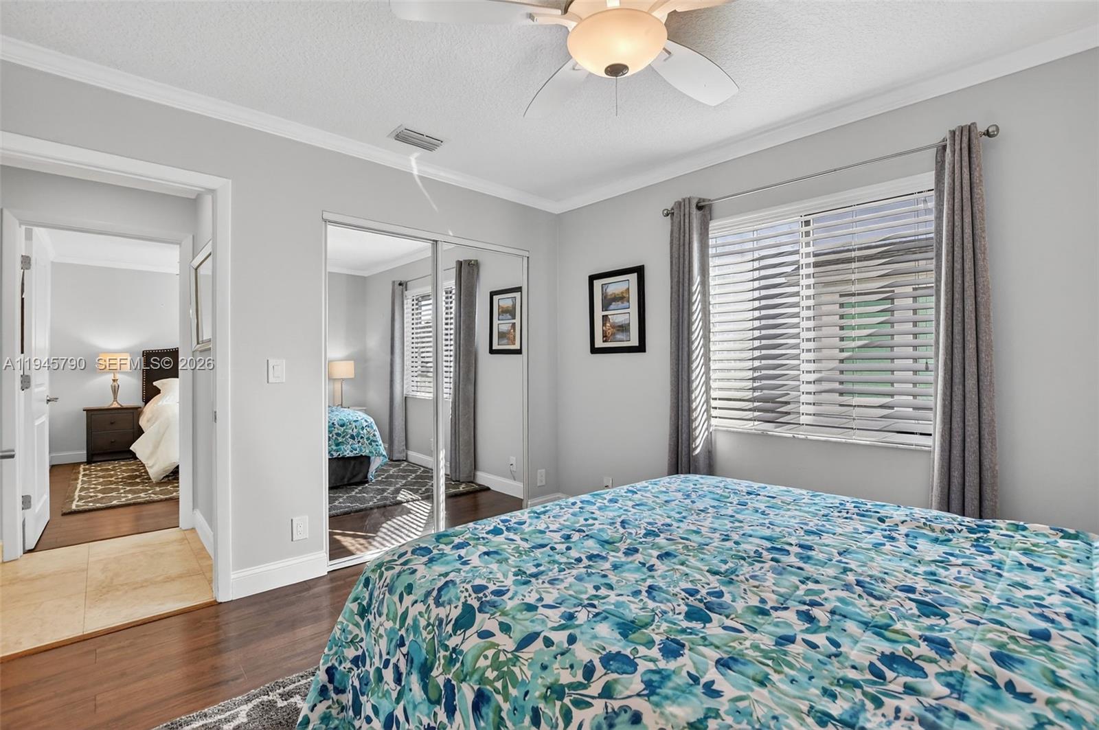 9943 Majorca Place Boca Raton, FL 33434 - Photo 35 of 48 a bedroom with a bed and a chandelier