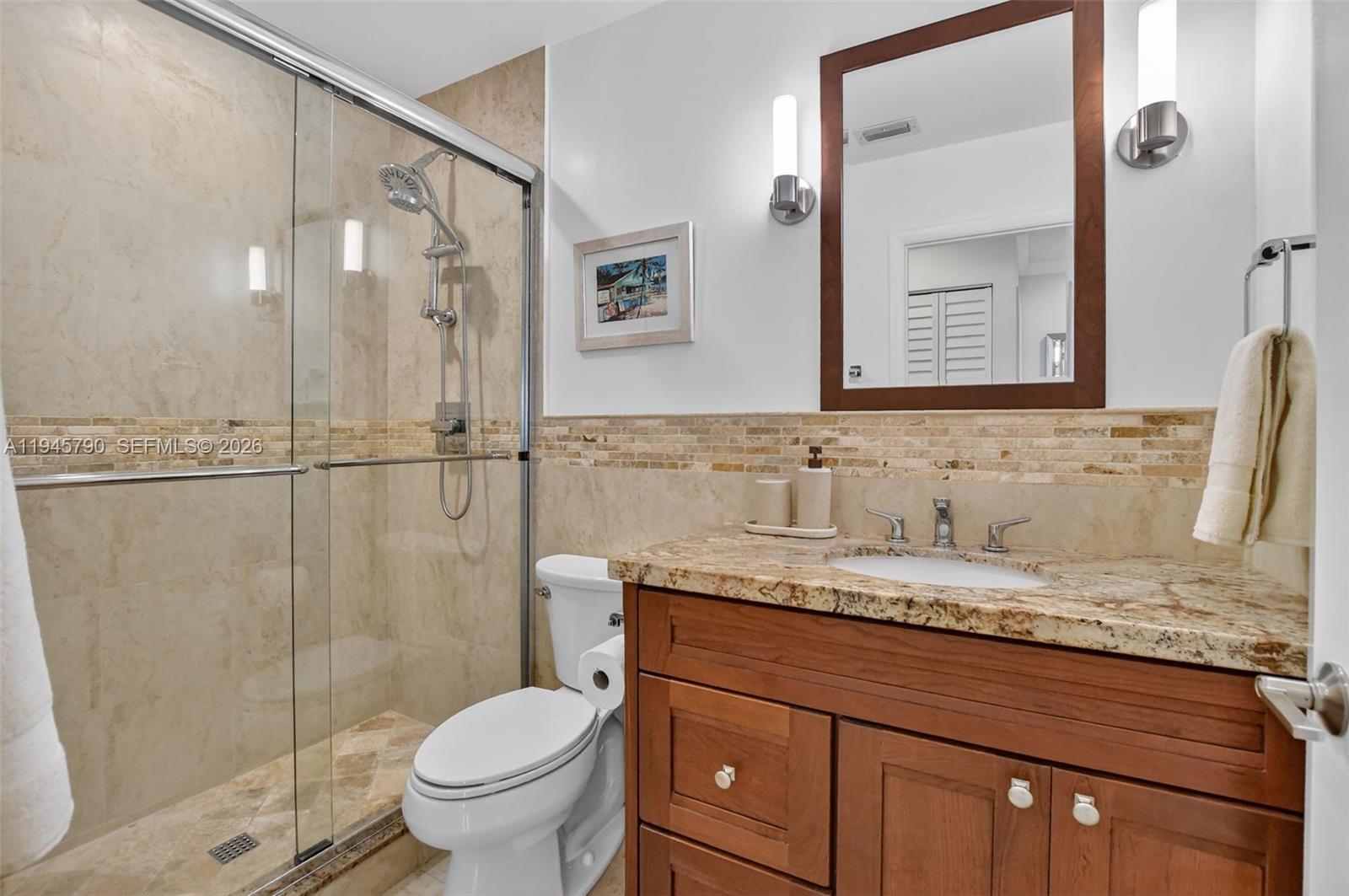9943 Majorca Place Boca Raton, FL 33434 - Photo 37 of 48 a bathroom with a granite countertop sink toilet and shower