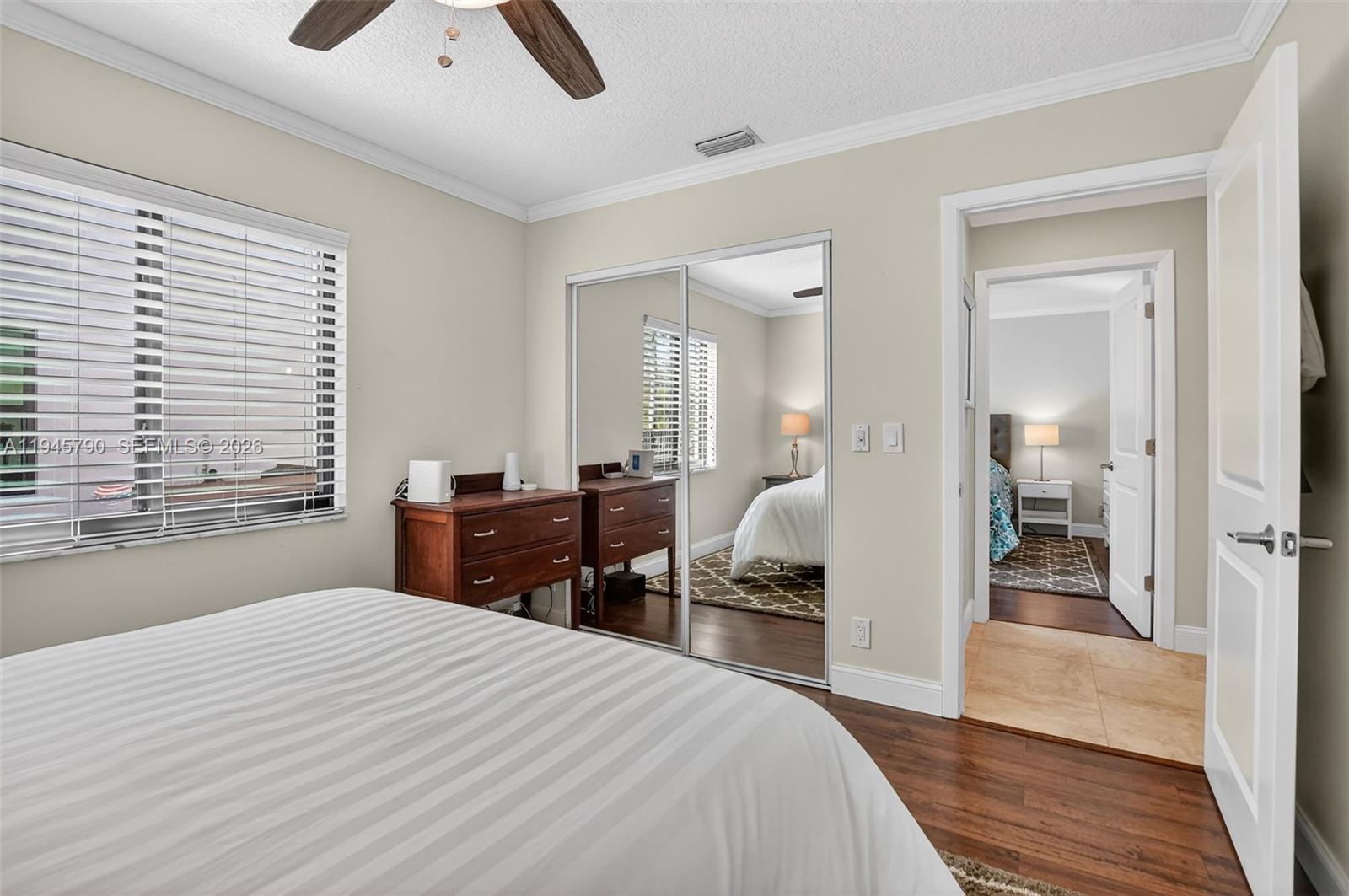 9943 Majorca Place Boca Raton, FL 33434 - Photo 40 of 48 a bedroom with a bed and wooden floor