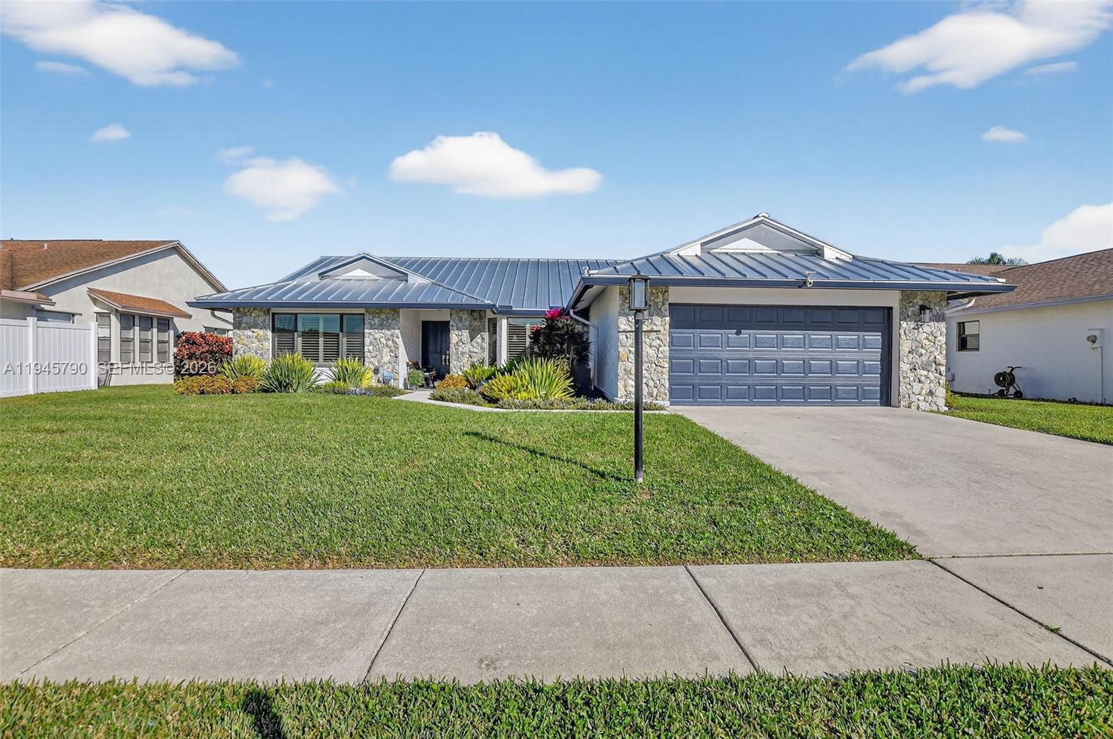 9943 Majorca Place Boca Raton, FL 33434 - Photo 4 of 48 a front view of a house with a yard