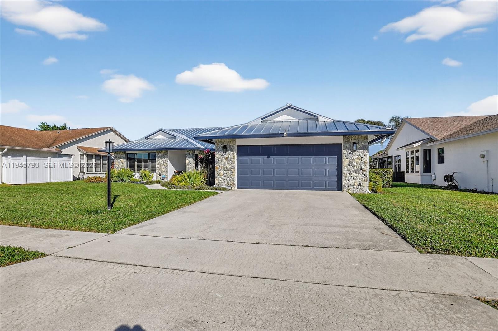 9943 Majorca Place Boca Raton, FL 33434 - Photo 5 of 48 a front view of house with yard