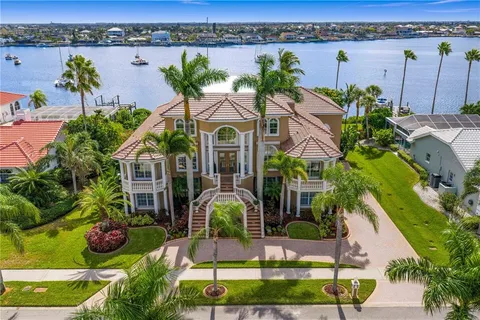 an aerial view of a house with a yard and lake view