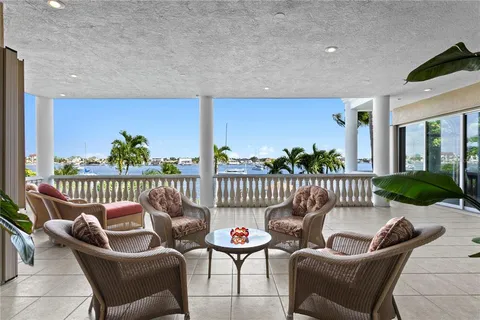 a living room with furniture a chandelier and a window