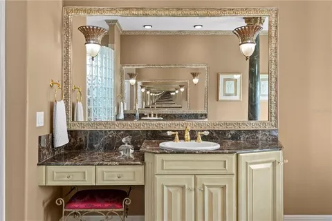 a view of a kitchen with a stove top oven a sink dishwasher and white cabinets with wooden floor
