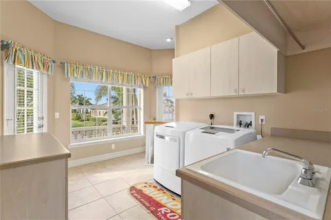 a view of a hallway with wooden floor and windows