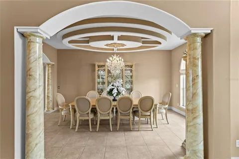 a dining room with furniture and chandelier