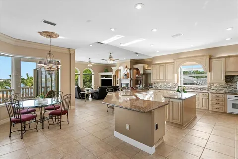 a large kitchen with lots of counter space and windows