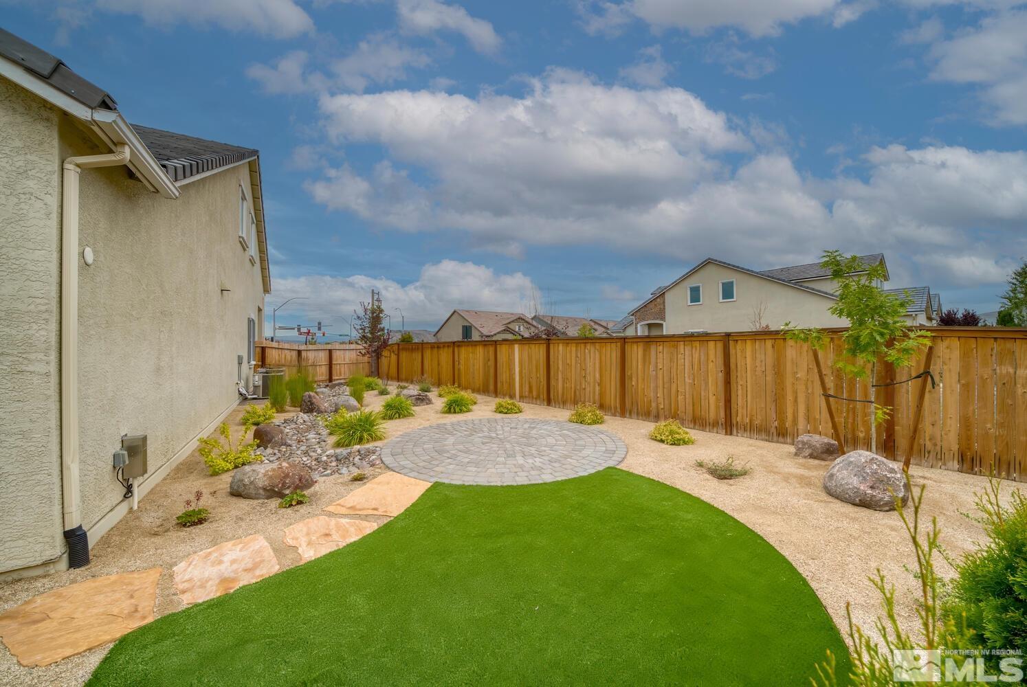 9500 Stony Hill Road Reno, NV 89521 - Photo 35 of 39 a view of a backyard with table and chairs with wooden fence