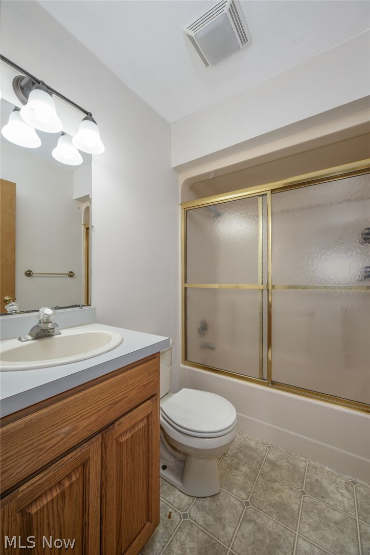 8464-8446 Tallmadge Road Diamond, OH 44412 - Photo 22 of 39 Full bath with vanity, light tile patterned floors, and combined bath / shower with glass door