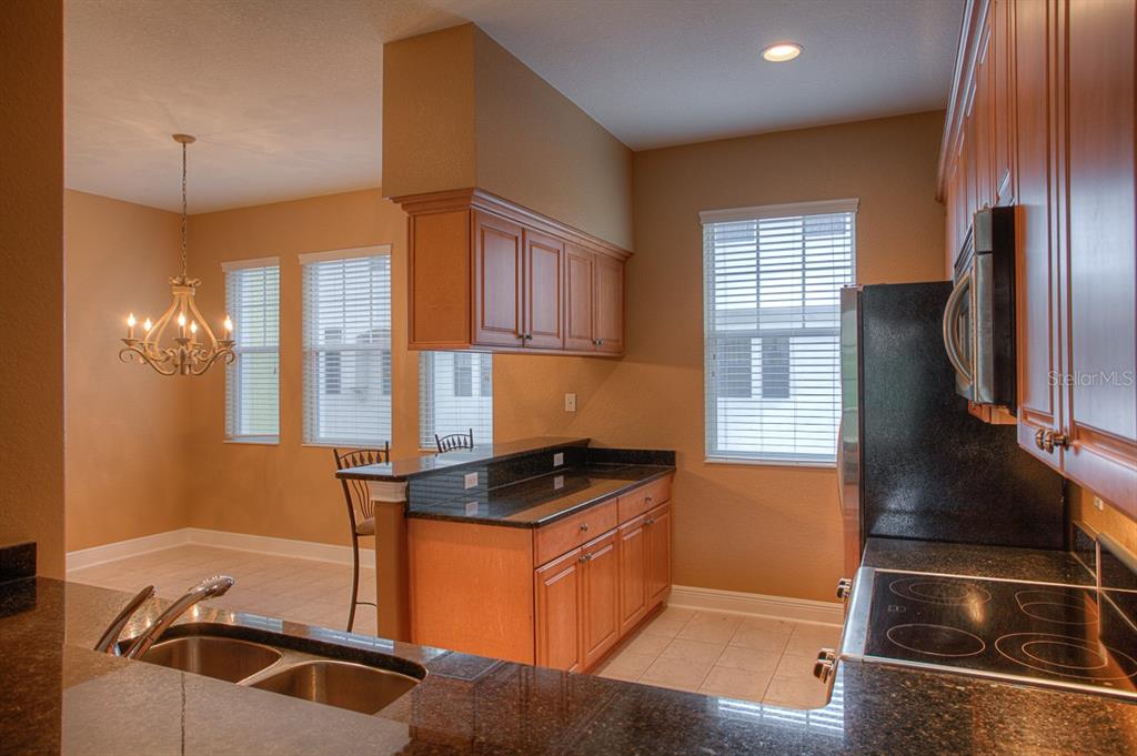 6021 Printery Street, Unit 106 Tampa, FL 33616 - Photo 9 of 23 a kitchen with a refrigerator and a sink