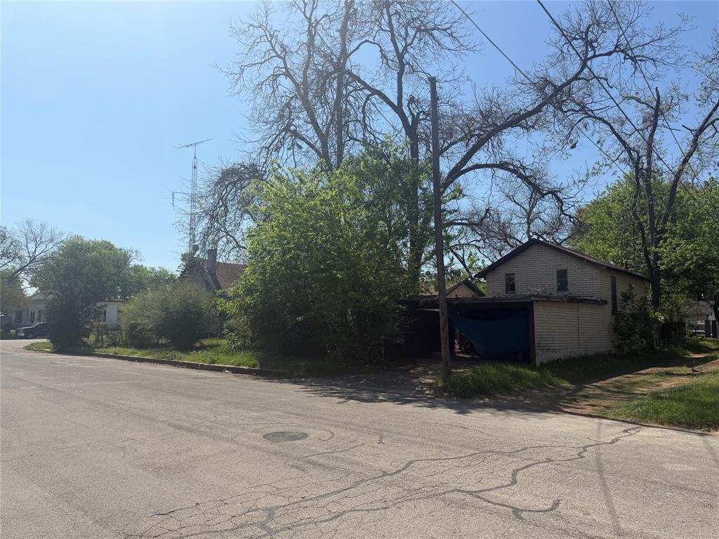 514 Tyler Street Waco, TX 76704 - Photo 7 of 11 a front view of a house with a yard and garage