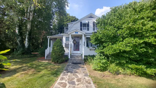a front view of a house with garden