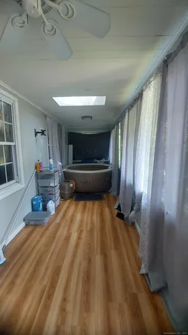 a room with wooden floor and furniture