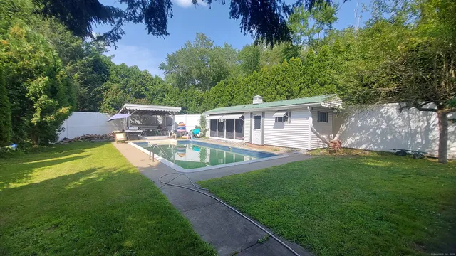 a view of house with a swimming pool