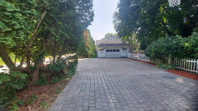 a view of a pathway with a wrought fence
