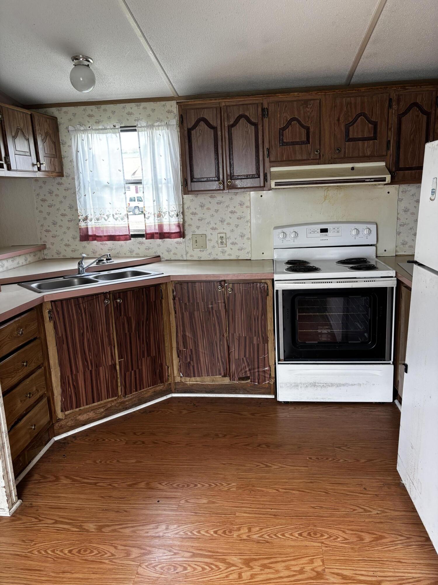 710 Commerce Avenue Iron Gate, VA 24448 - Photo 4 of 6 a kitchen with stainless steel appliances granite countertop a stove a sink and a microwave