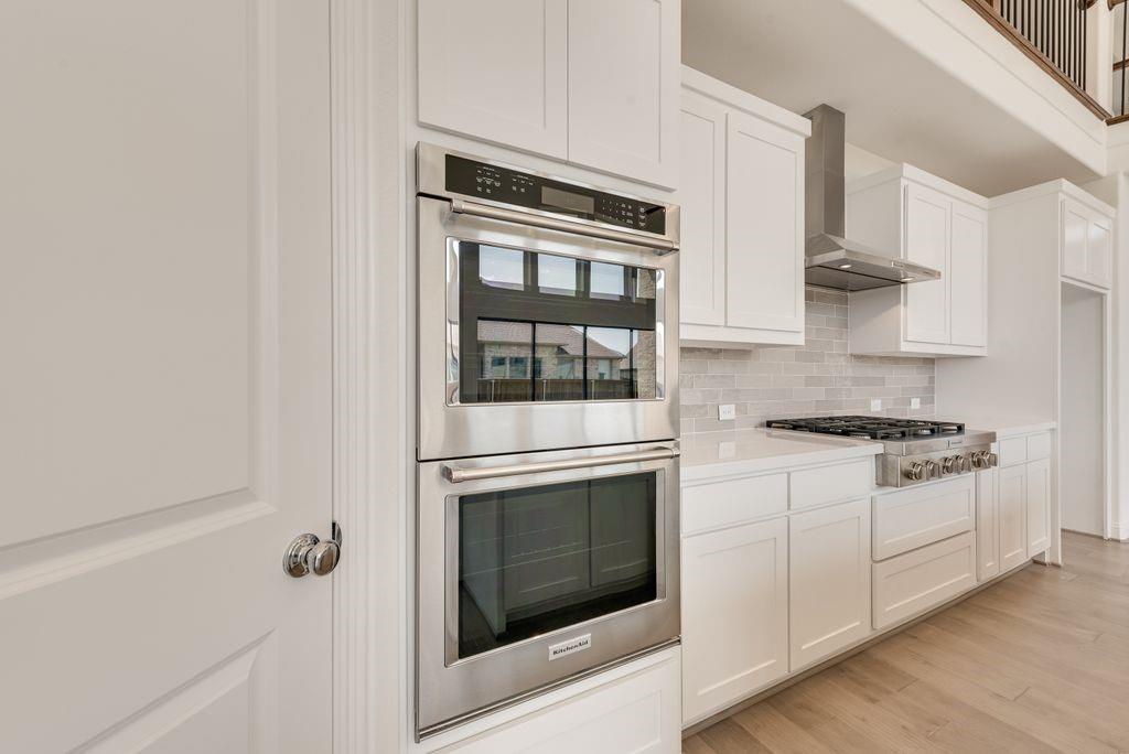 2807 Augustus Way Mansfield, TX 76063 - Photo 13 of 40 a kitchen with stainless steel appliances granite countertop white cabinets and white stove