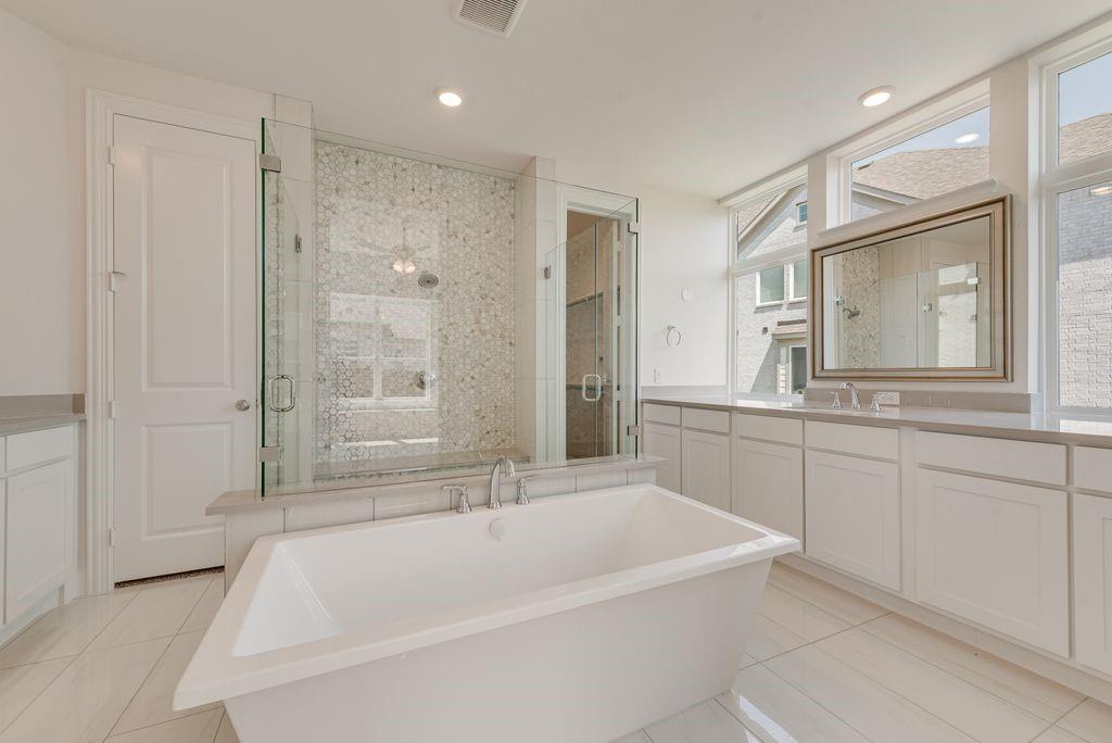 2807 Augustus Way Mansfield, TX 76063 - Photo 20 of 40 a spacious bathroom with a tub sink and mirror