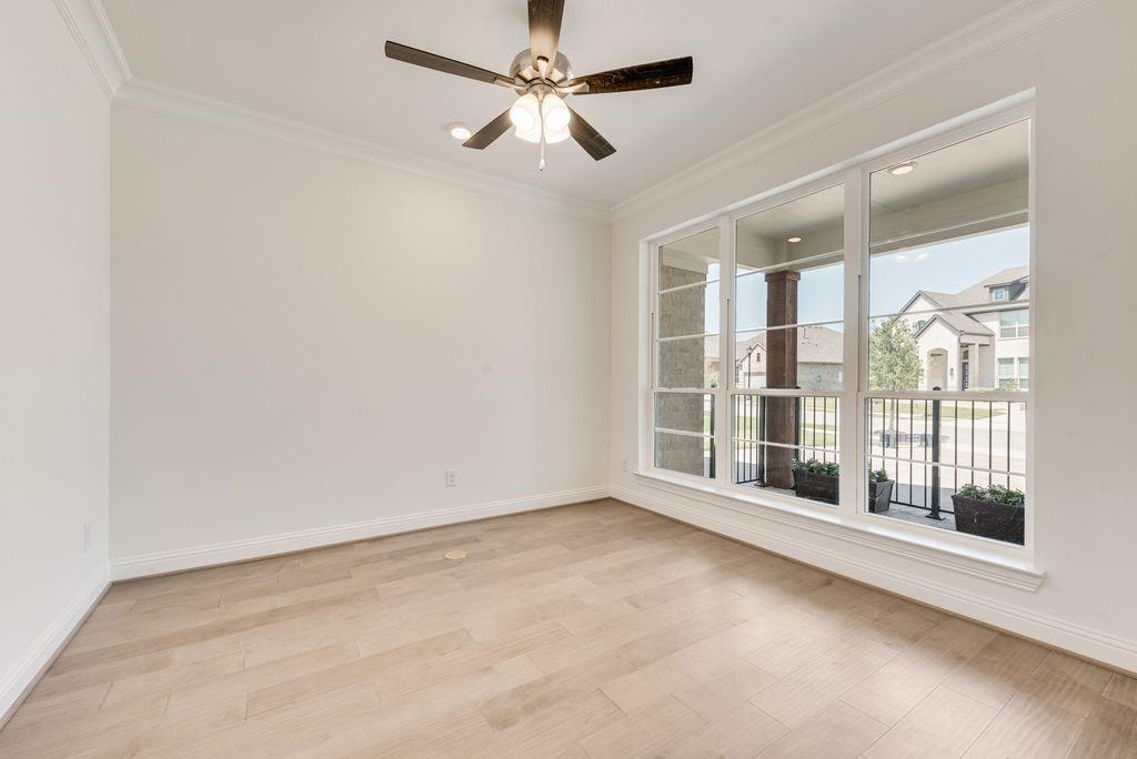 2807 Augustus Way Mansfield, TX 76063 - Photo 22 of 40 an empty room with chandelier fan and windows