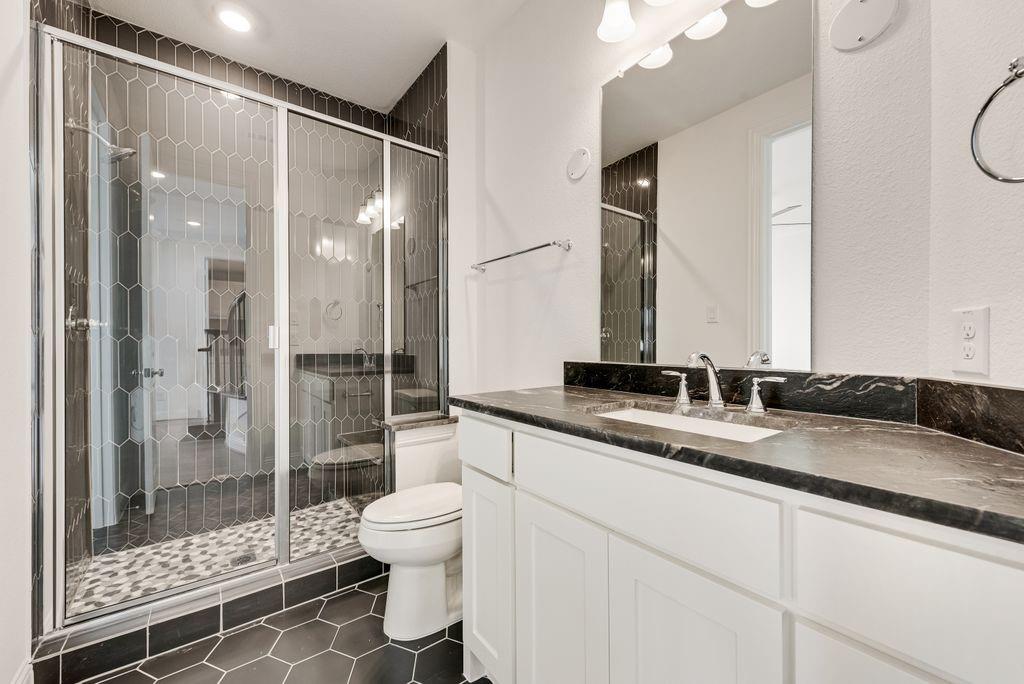 2807 Augustus Way Mansfield, TX 76063 - Photo 25 of 40 a bathroom with a granite countertop sink mirror vanity and toilet
