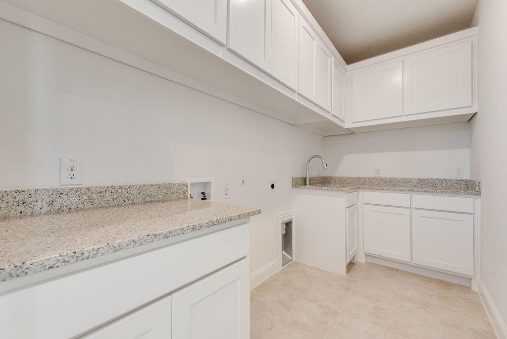 2807 Augustus Way Mansfield, TX 76063 - Photo 26 of 40 a kitchen with granite countertop white cabinets and a sink