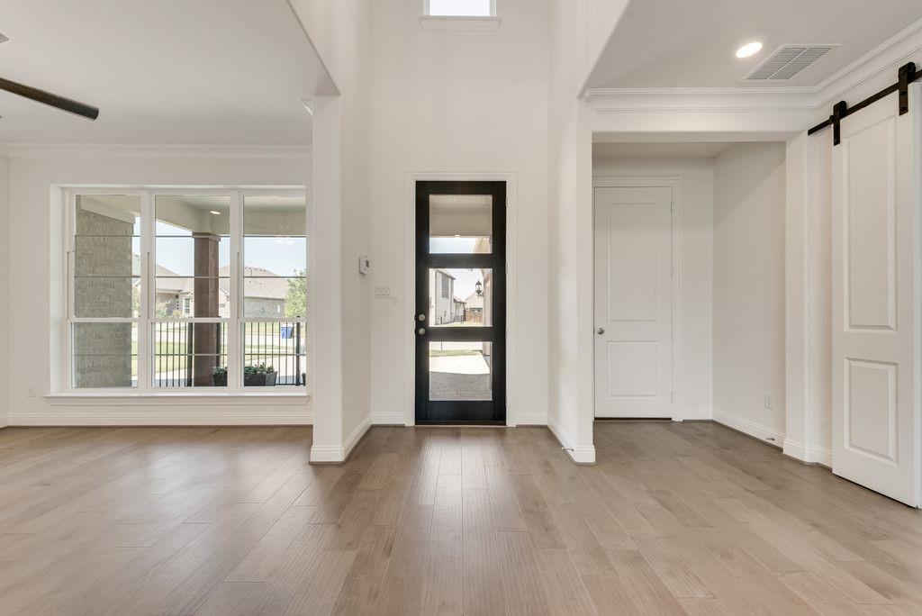 2807 Augustus Way Mansfield, TX 76063 - Photo 5 of 40 a view of an empty room with wooden floor and window