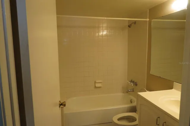 a bathroom with a shower and a sink