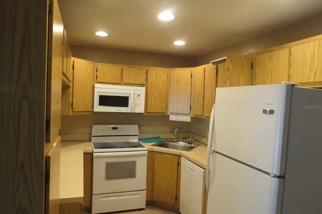 a white refrigerator freezer sitting in a kitchen