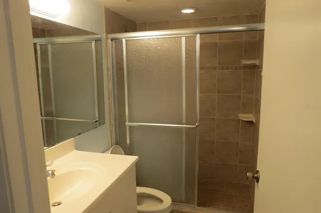 a bathroom with a shower and a toilet