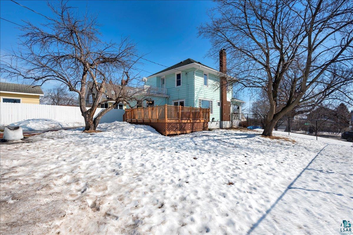 4345 West 8th Street Duluth, MN 55807 - Photo 12 of 31 Snow covered back of property with a deck and a chimney