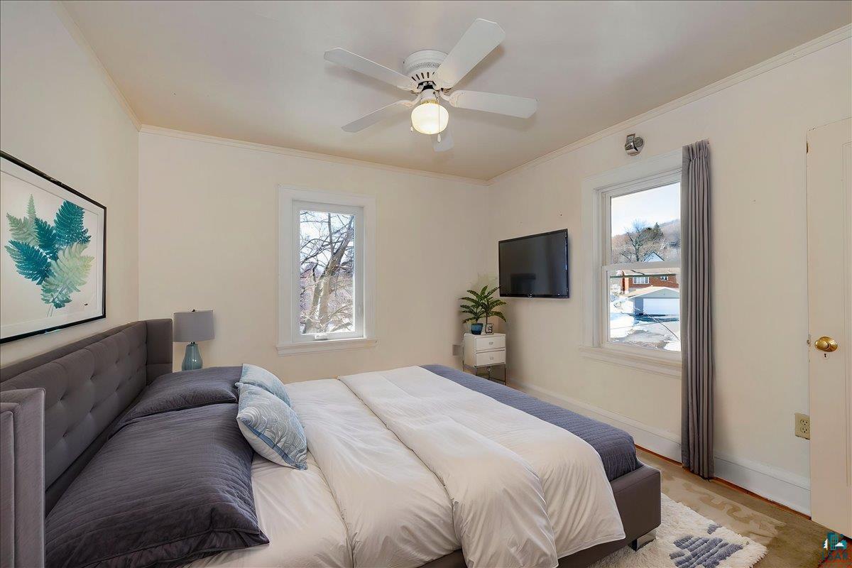4345 West 8th Street Duluth, MN 55807 - Photo 19 of 31 Bedroom featuring ornamental molding, multiple windows, and a ceiling fan