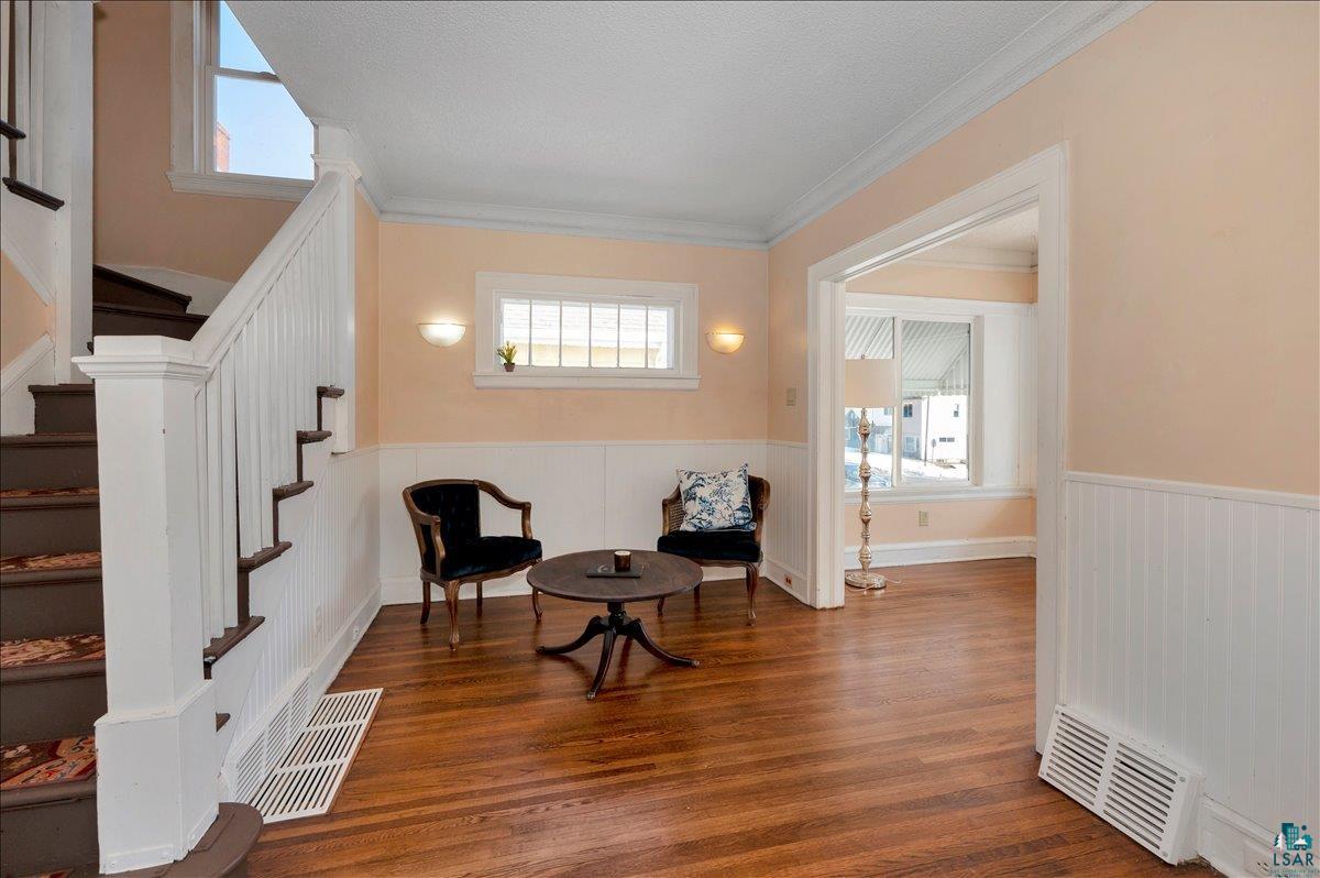 4345 West 8th Street Duluth, MN 55807 - Photo 8 of 31 Sitting room with wood finished floors, ornamental molding, and a wainscoted wall