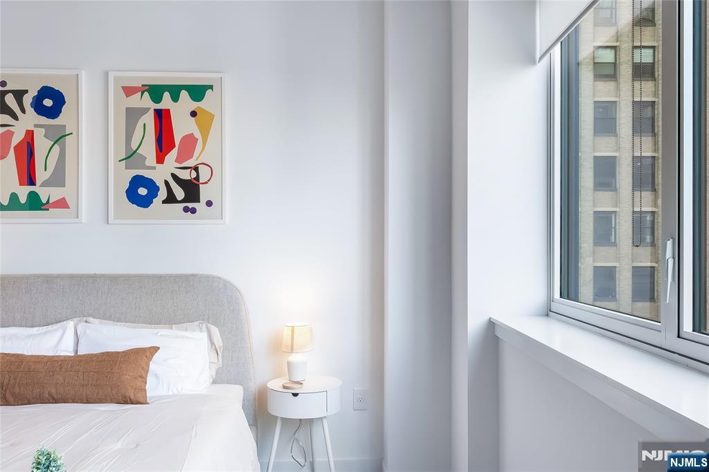 10 Commerce Court, Unit 2E Newark, NJ 07102 - Photo 11 of 17 a living room with furniture and wall painting