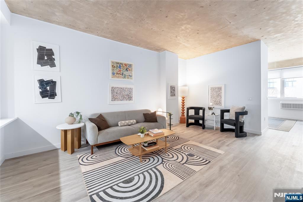 10 Commerce Court, Unit 2E Newark, NJ 07102 - Photo 3 of 17 a living room with furniture and wooden floor