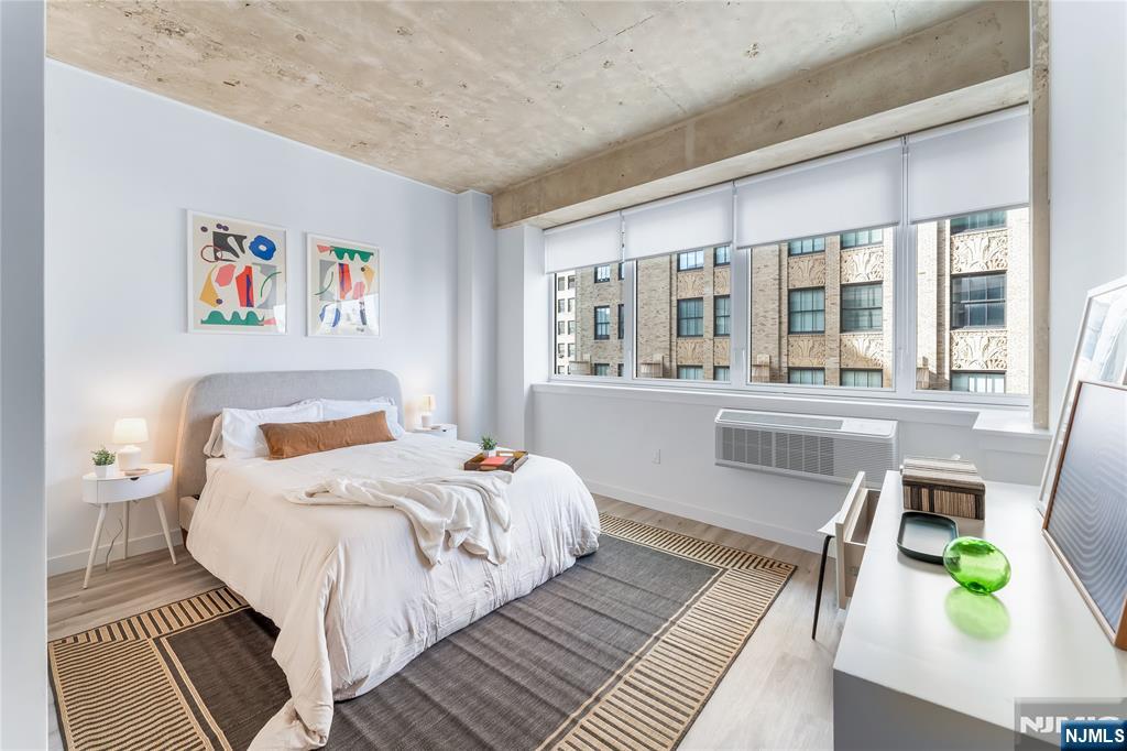 10 Commerce Court, Unit 2E Newark, NJ 07102 - Photo 8 of 17 a bedroom with a bed and a large window