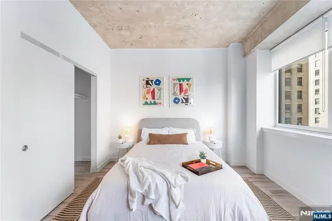 a bedroom with a bed and a table