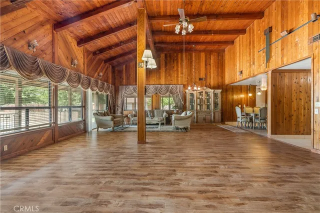a view of a hall with the floor to ceiling windows and a basket ball poll