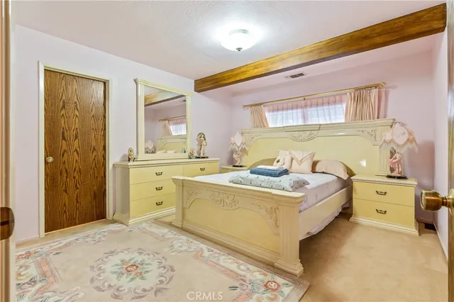 a bed room with a bed and a dresser