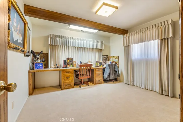a spacious bedroom with a bed couch and a large window