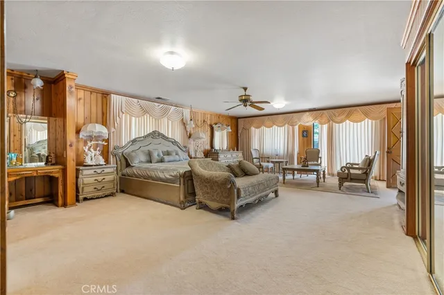 a bed room with a bed and a large window