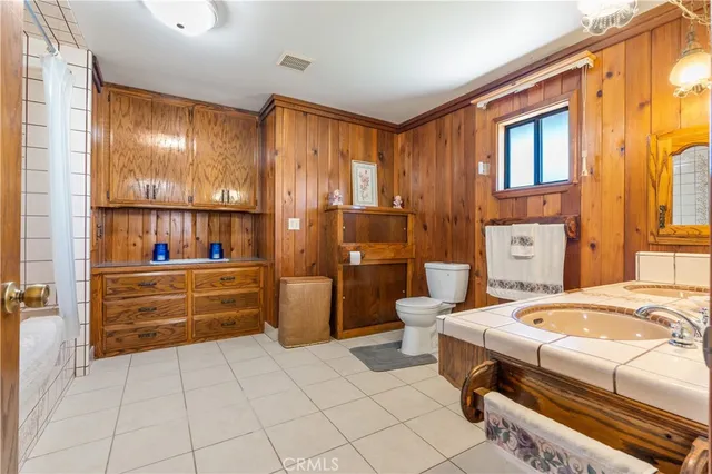 a bathroom with a sink a large mirror and a shower